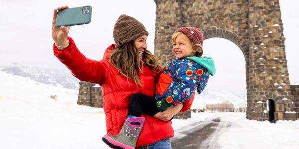 Mom and daughter take a selfie at Roosevelt Arch